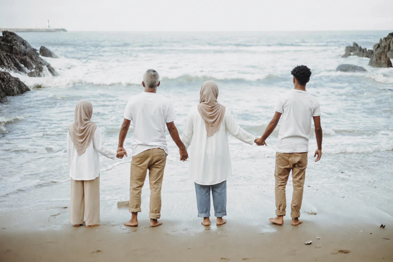 A Muslim family standing together by the sea — illustrating Islamic parenting across generations